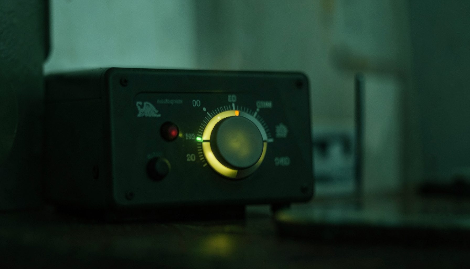 A radio dial glowing softly in a dim room, muted greens and greys, relaxed atmosphere